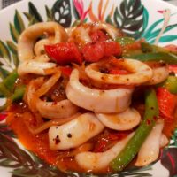Calamari in a spicy tomato sauce with green peppers and spanish sausage