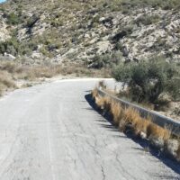 A cracked mountain road in Spain. The cracks near the side of the road next to the big drop are a little concerning.